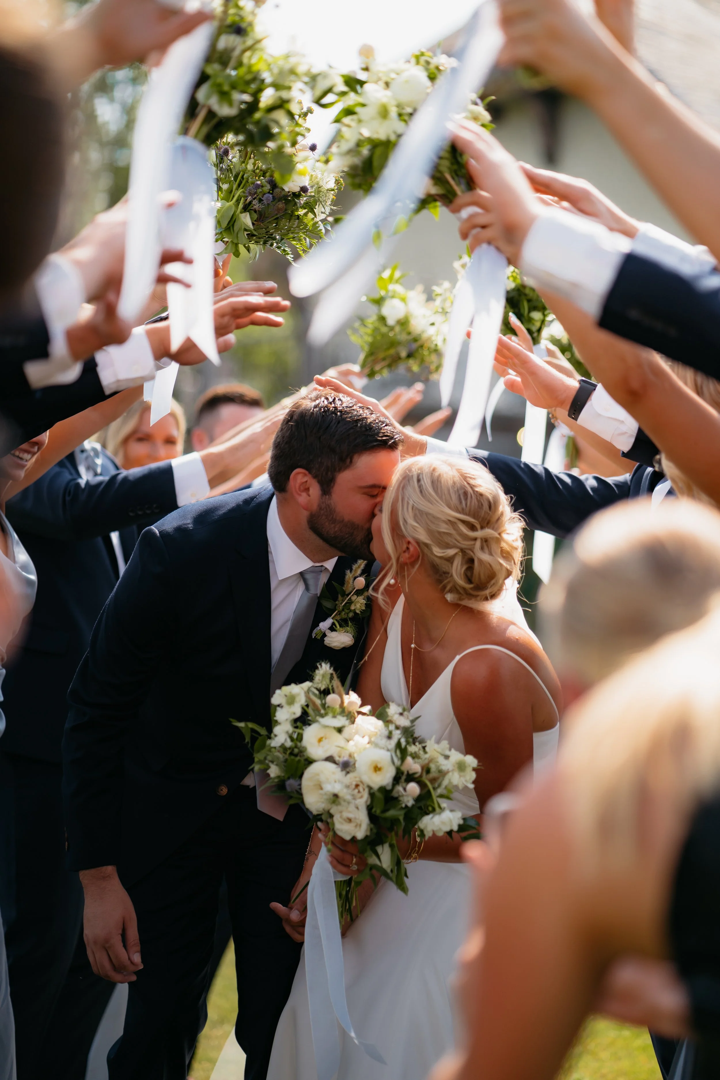 Bride and groom sharing first kiss as newlyweds